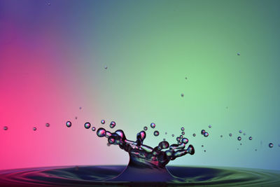 Close-up of water splashing against blue background