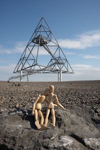 Mother with toy on land against sky