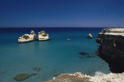 Scenic view of sea against clear blue sky