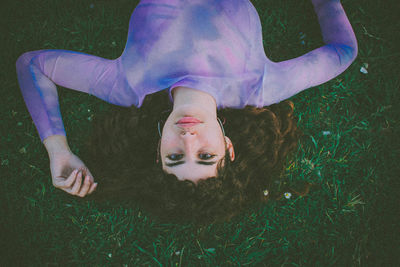 High angle portrait of woman lying on grass