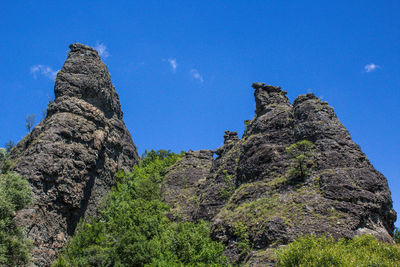 Low angle view of rock formations against sky