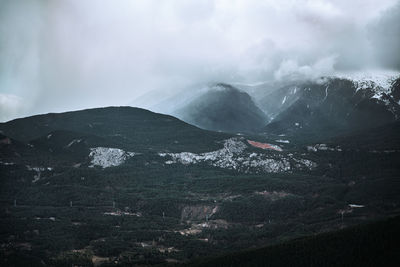 Aerial view of snowcapped mountains against sky