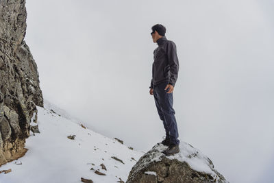 Rear view of man standing on rock