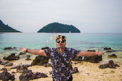 Portrait of man standing on beach