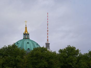 Low angle view of the berlin dome and the fernsehturm against the sky