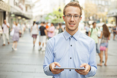 Portrait of young man standing outdoors