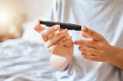 Midsection of woman using mobile phone