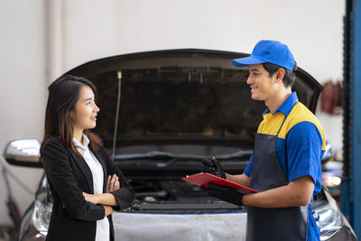 Side view of a smiling young woman working