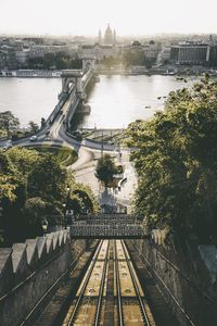 High angle view of railroad tracks by river in city