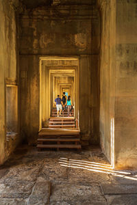 People walking in corridor of historic building