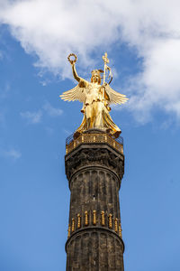 Low angle view of statue of liberty against sky