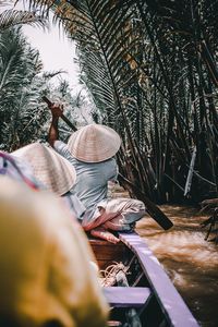 Woman standing on tree trunk