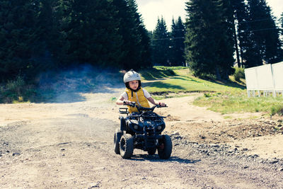 Portrait of man riding motorcycle on road
