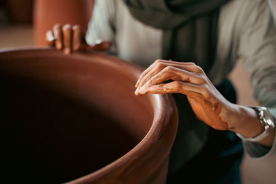 Midsection of potter making pottery