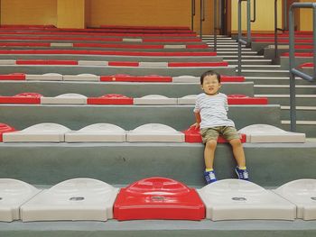 Full length of boy with red umbrella