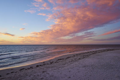 Scenic view of beach against sky during sunset