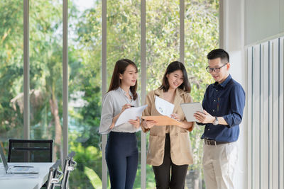 Group of people looking away while standing on window