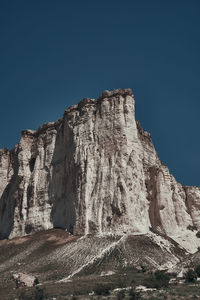 Low angle view of rock formations against sky