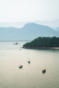 High angle view of boats sailing in sea against sky