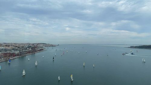High angle view of sailboats in sea against sky