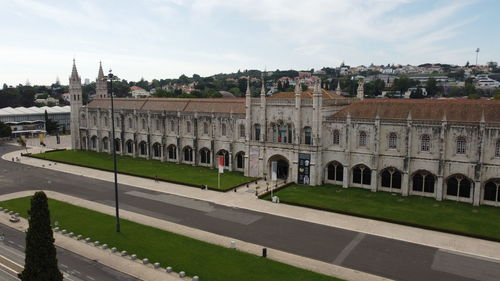 Buildings in town against cloudy sky