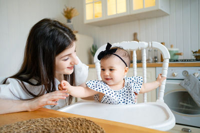 High angle view of mother and daughter at home