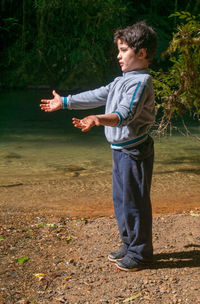 Side view of boy standing on land