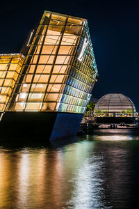 Low angle view of illuminated building against sky at night