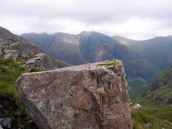 Scenic view of mountains against cloudy sky