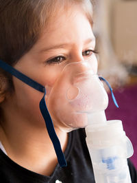 Close-up portrait of girl drinking glass