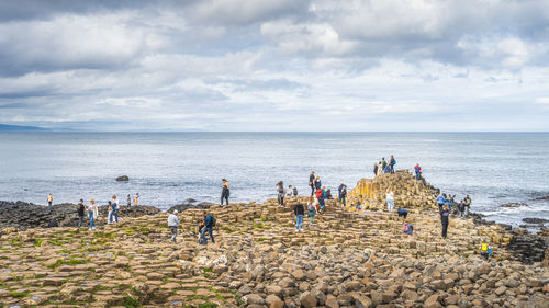 People on beach against sky