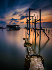 Pier over lake against sky