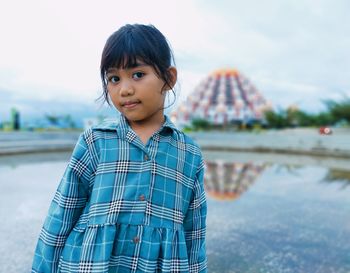 Portrait of cute boy standing in water