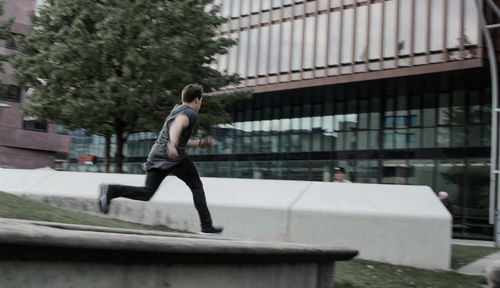 Side view of man running in city
