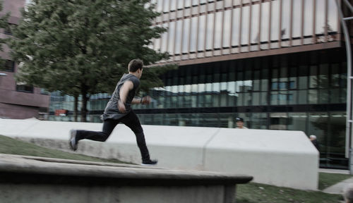 Side view of man against building in city