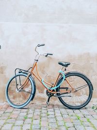 Bicycle leaning on wall