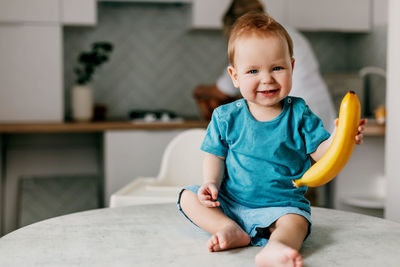 Portrait of cute girl sitting at home