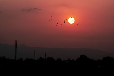 Scenic view of silhouette mountain against orange sky