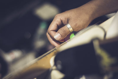 Midsection of person playing guitar