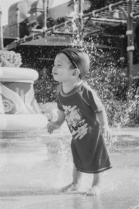 Full length of girl playing in water