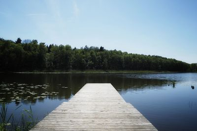 Pier over lake against sky