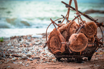 Close-up of rusty chain on beach