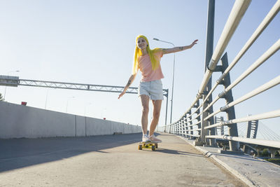 Full length of man standing on bridge against sky