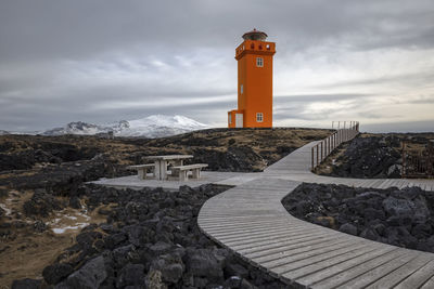 Orange lighthouse in the west part of iceland in wintertime.
