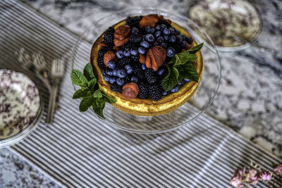 Cheesecake and berries with mint leaves