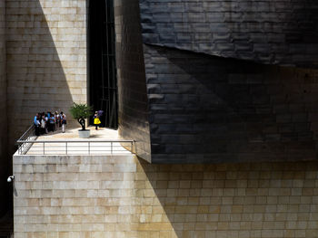 People on wall of building