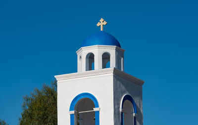 Zia and a blue white village church in front of the turkish mainland in the north on the island kos 