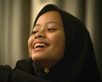 Close-up of smiling girl wearing headscarf