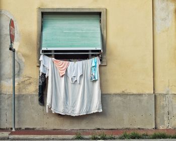 Low angle view of clothes drying against building