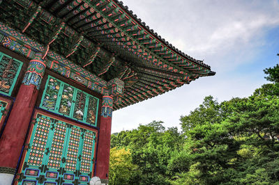 Low angle view of building against cloudy sky